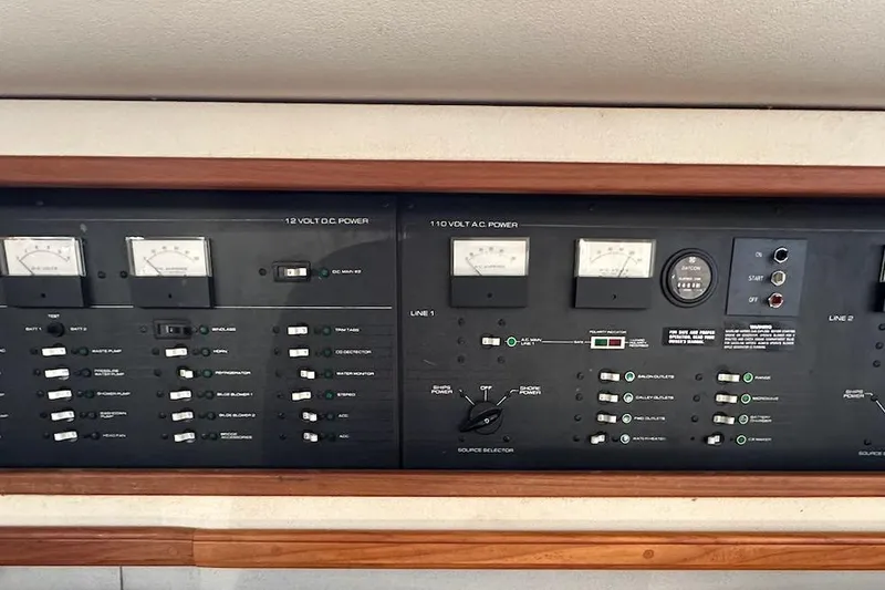 Slide: The Image of Control panel of a 1988 Carver 38 Santego yacht, featuring voltage meters and switches. - 28