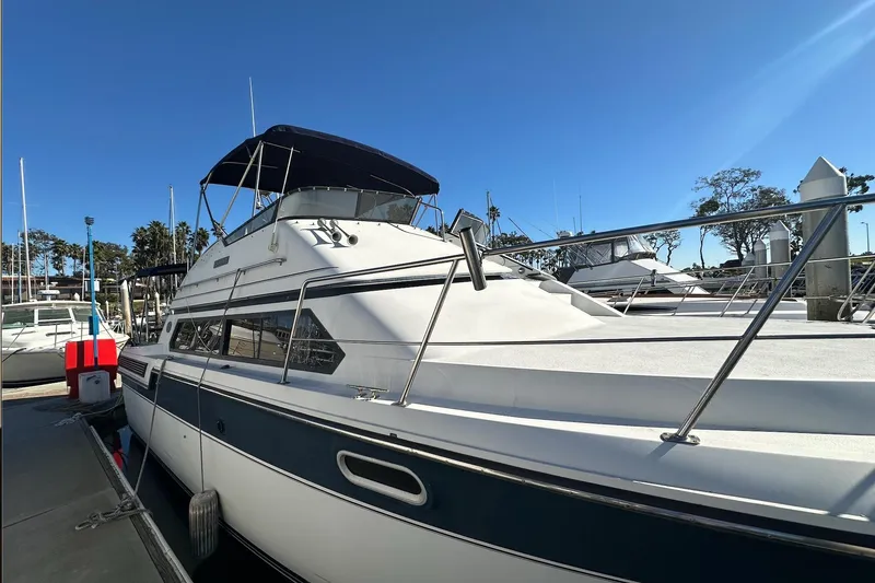 Slide: The Image of 1988 Carver 38 Santego yacht docked under clear blue sky. - 3