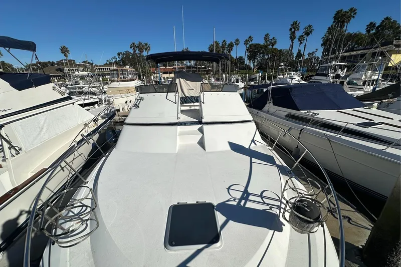 Slide: The Image of 1988 Carver 38 Santego yacht docked in a marina, surrounded by other boats. - 4