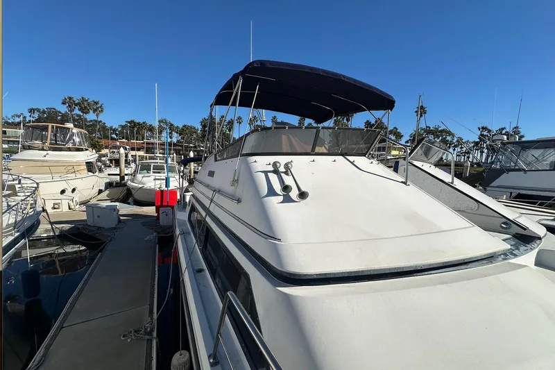 Slide: The Image of 1988 Carver 38 Santego yacht docked at marina under clear blue sky. - 5
