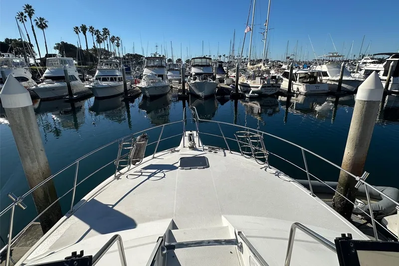 Slide: The Image of 1988 Carver 38 Santego yacht docked in a marina with clear blue skies. - 6