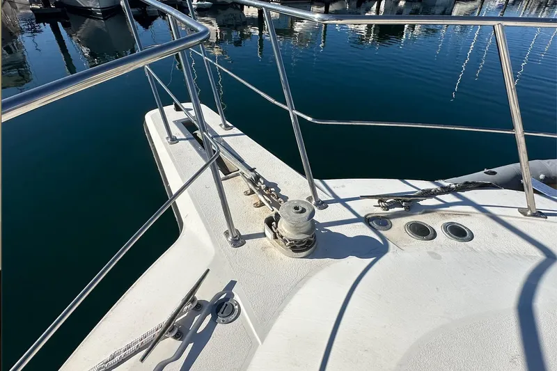 Slide: The Image of Bow of 1988 Carver 38 Santego yacht with railing and winch, docked in marina. - 8