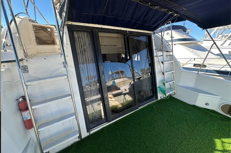 Slide: The Image of 1988 Carver 38 Santego yacht with sliding glass doors and outdoor carpeted deck. - 9