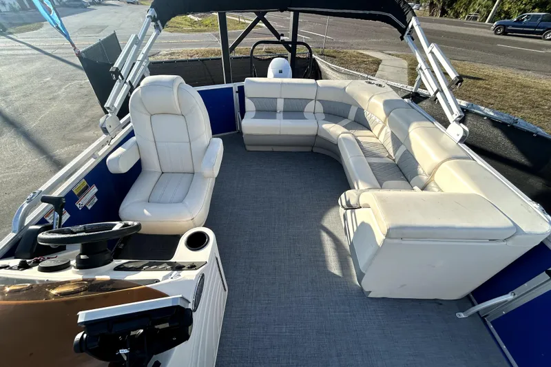Slide: The Image of 2023 Lexington 321 CRUISE pontoon boat with spacious seating and modern design. - 13