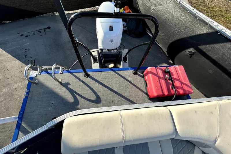 Slide: The Image of 2023 Lexington 321 CRUISE pontoon boat interior with plush seating and helm. - 15