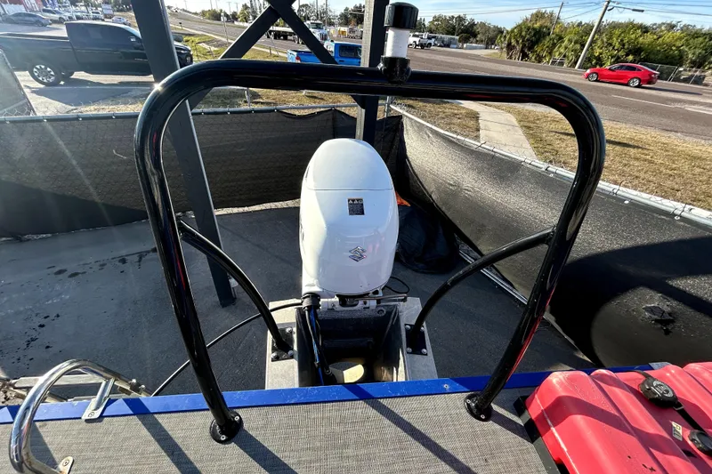 Slide: The Image of 2023 Lexington 321 CRUISE pontoon boat interior with plush seating and steering console. - 16