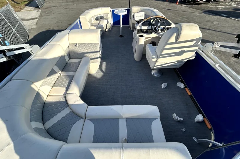 Slide: The Image of 2023 Lexington 321 CRUISE boat with Suzuki outboard motor in a fenced area. - 18