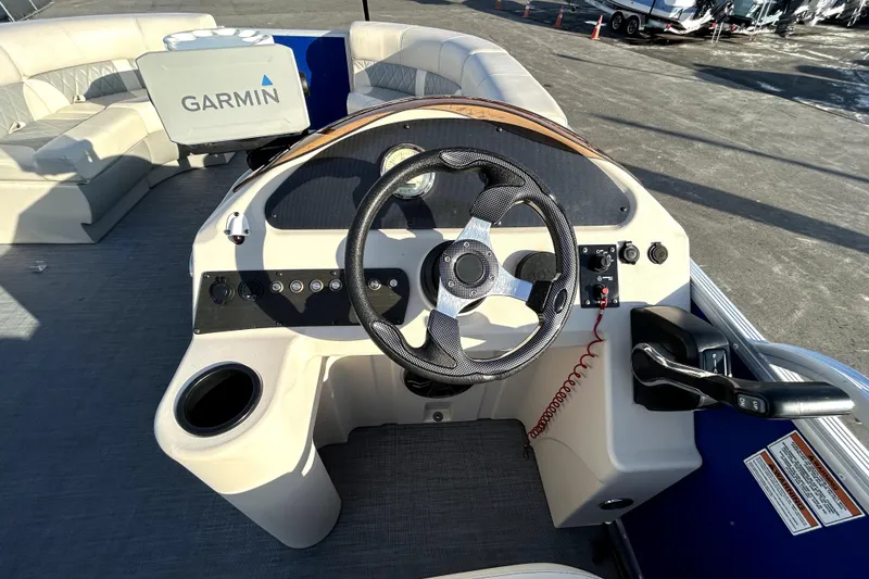 Slide: The Image of 2023 Lexington 321 CRUISE pontoon boat interior with seating and steering console. - 20