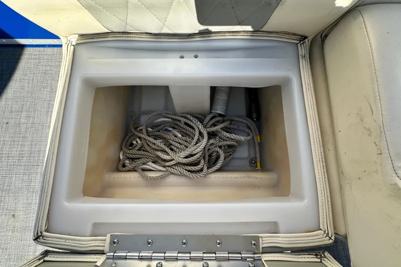 Slide: The Image of Storage compartment in 2023 Lexington 321 CRUISE boat with coiled rope inside. - 27