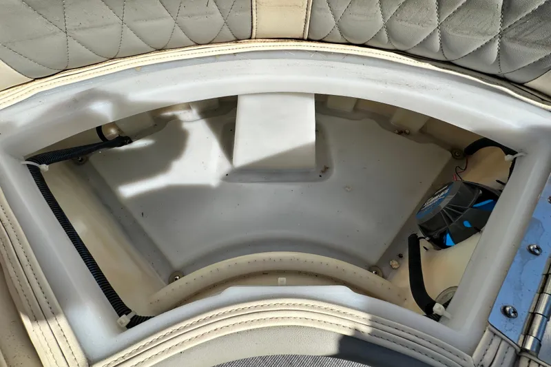 Slide: The Image of 2023 Lexington 321 CRUISE boat storage compartment with quilted upholstery and visible wiring. - 30