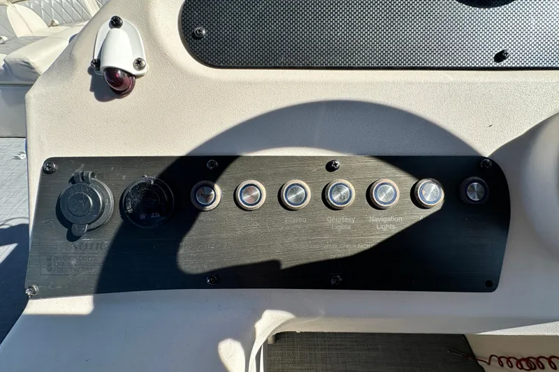 Slide: The Image of Control panel of 2023 Lexington 321 CRUISE boat with various switches and outlets. - 38