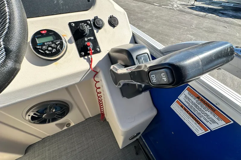 Slide: The Image of 2023 Lexington 321 CRUISE boat control panel with throttle and audio system. - 42