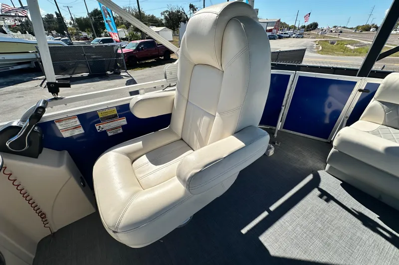 Slide: The Image of Luxurious captain's chair on 2023 Lexington 321 CRUISE boat, featuring plush white upholstery. - 43