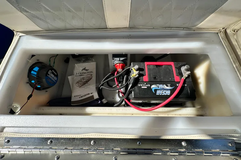 Slide: The Image of 2023 Lexington 321 CRUISE battery compartment with manual and speaker. - 46