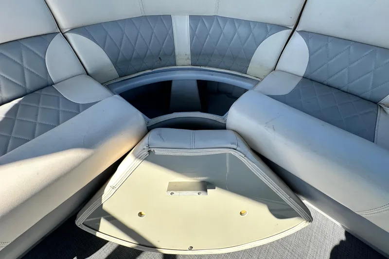 Slide: The Image of 2023 Lexington 321 CRUISE boat interior with cushioned seating and storage compartment. - 48