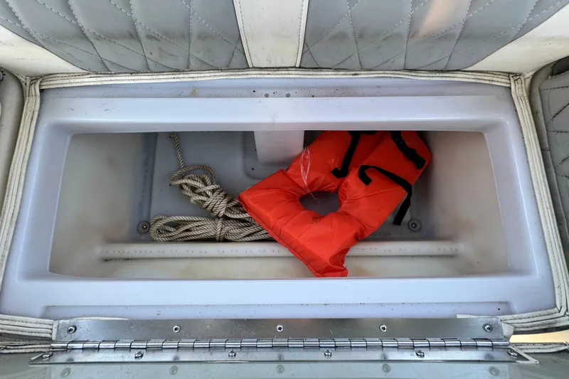 Slide: The Image of Storage compartment in 2023 Lexington 321 CRUISE with life jacket and rope. - 52