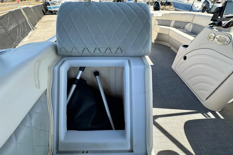 Slide: The Image of 2023 Lexington 321 CRUISE boat interior with storage compartment and seating area. - 54