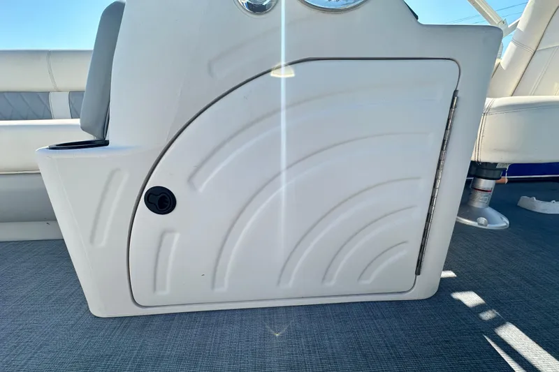 Slide: The Image of 2023 Lexington 321 CRUISE boat interior with white storage compartment and seating. - 56