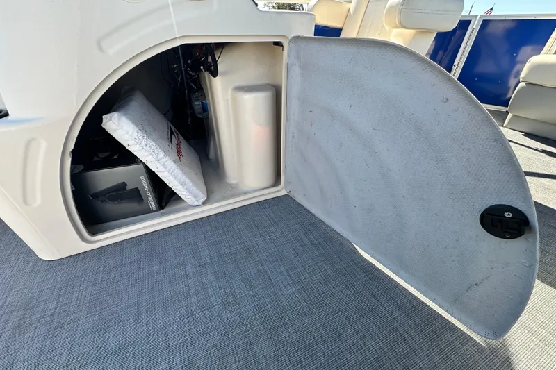 Slide: The Image of Open storage compartment in 2023 Lexington 321 CRUISE boat, showing interior equipment and accessories. - 57