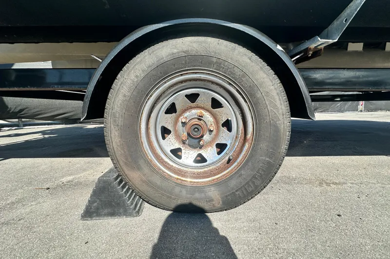 Slide: The Image of Close-up of a 2023 Lexington 321 CRUISE trailer wheel on pavement. - 59