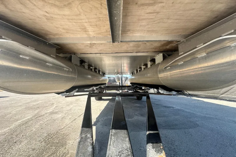 Slide: The Image of Underneath view of 2023 Lexington 321 CRUISE pontoon boat, showcasing dual pontoons and structural details. - 62