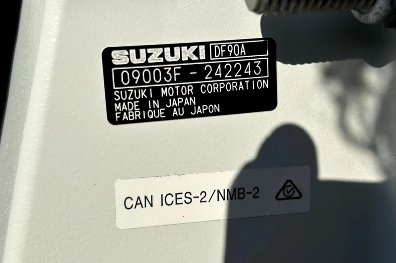Slide: The Image of Label on a Suzuki DF90A engine, made in Japan, with compliance markings. - 64