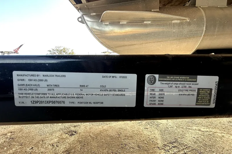 Slide: The Image of Trailer label showing specifications and safety standards, manufactured by Warlock Trailers, 2023 Lexington 321. - 65