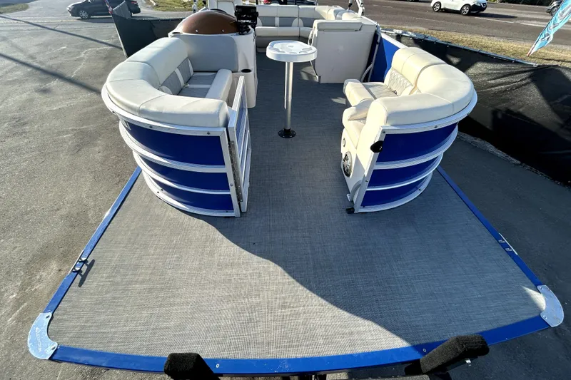 Slide: The Image of 2023 Lexington 321 CRUISE pontoon boat on trailer, rear view, blue and silver design. - 9