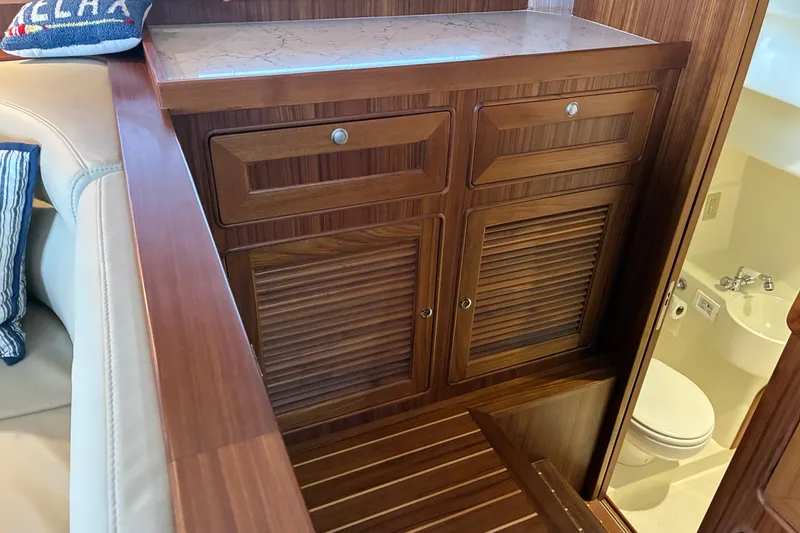Slide: The Image of 2024 Helmsman Trawlers 43E PILOTHOUSE interior with teak cabinetry and dayhead. - 10
