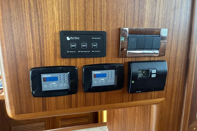 Slide: The Image of 2024 Helmsman Trawlers 43E PILOTHOUSE thermostat controls and digital displays - 18