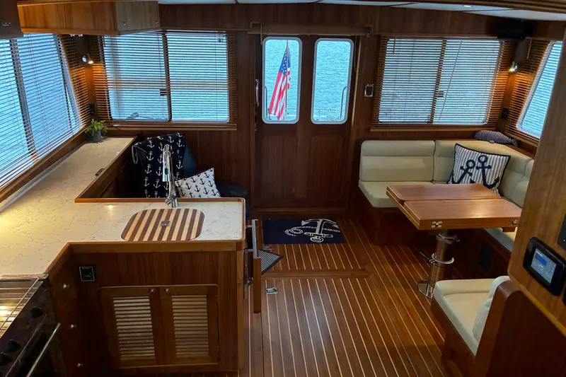 Slide: The Image of Luxurious 2024 Helmsman Trawlers 43E Pilothouse salon viewed from pilothouse looking aft - 30