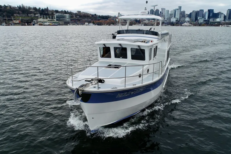 Slide: The Image of 2024 Helmsman Trawlers 43E Pilothouse cruising near city Seattle. - 4