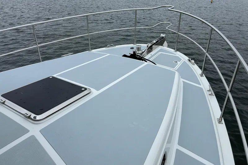 Slide: The Image of Bow view of 2024 Helmsman Trawlers 43E Pilothouse on water. - 52