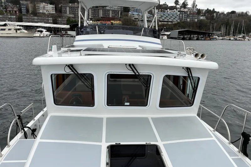 Slide: The Image of 2024 Helmsman Trawlers 43E Pilothouse exterior pilothouse view. - 57