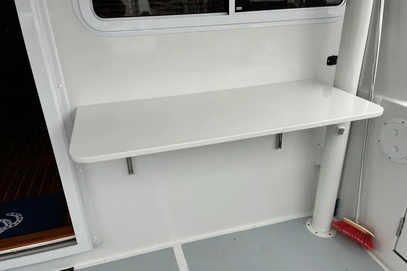 Slide: The Image of 2024 Helmsman Trawlers 43E PILOTHOUSE, fold up / fold down cockpit table. - 78