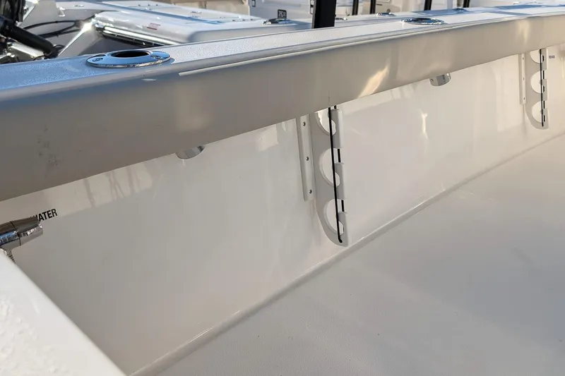 Slide: The Image of 2026 Key West 210 Bay Reef boat interior, featuring rod holders and sleek design. - 11