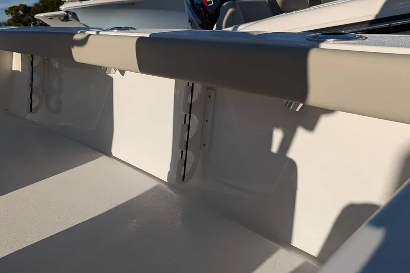 Slide: The Image of 2026 Key West 210 Bay Reef boat interior detail with rod holders and seating. - 12