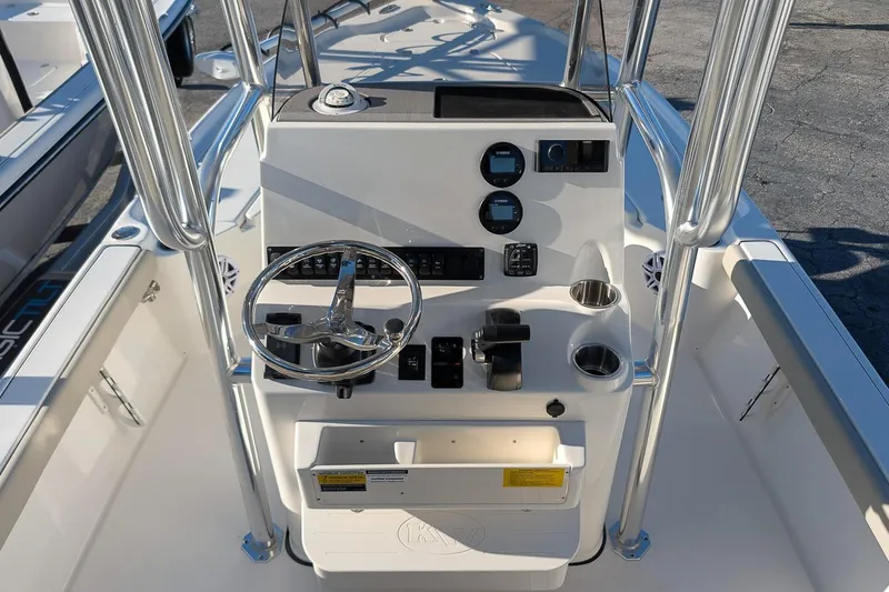 Slide: The Image of 2026 Key West 210 Bay Reef boat console with steering wheel and controls. - 13