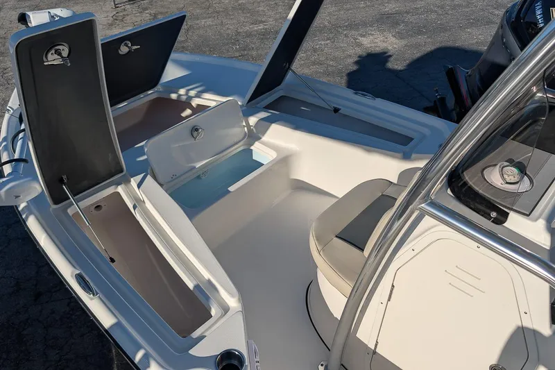 Slide: The Image of 2026 Key West 210 Bay Reef boat interior with open storage compartments. - 17