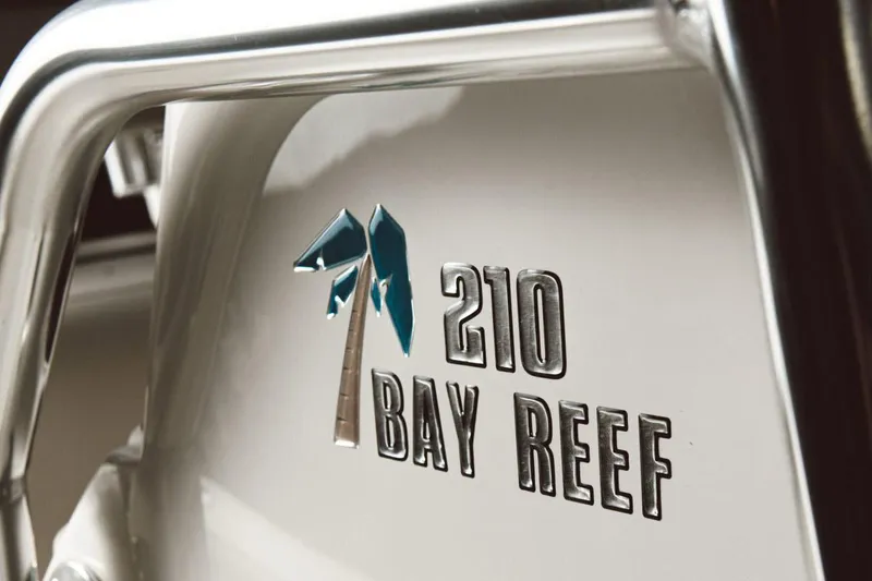 Slide: The Image of 2026 Key West 210 Bay Reef boat on trailer, featuring spacious deck and seating. - 6