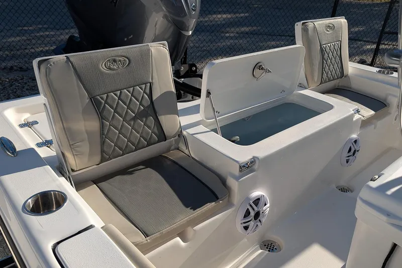 Slide: The Image of 2026 Key West 210 Bay Reef boat interior with cushioned seating and storage compartment. - 8