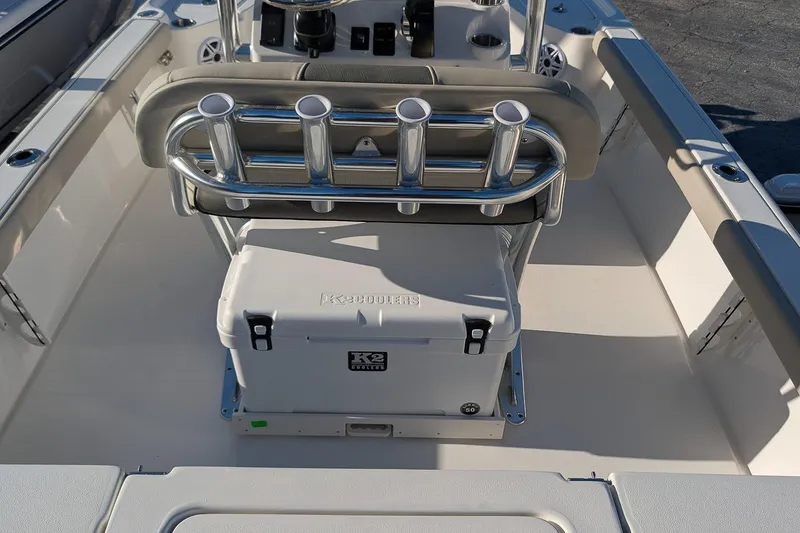 Slide: The Image of 2026 Key West 210 Bay Reef boat interior with rod holders and cooler. - 9