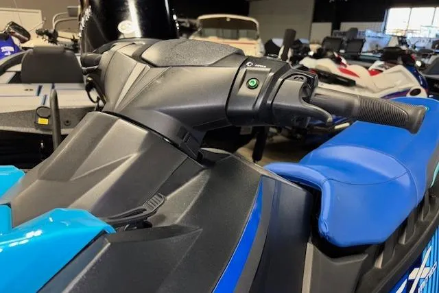 Slide: The Image of 2023 Yamaha WaveRunner EX Limited, blue seat and handlebars, in a showroom setting. - 12