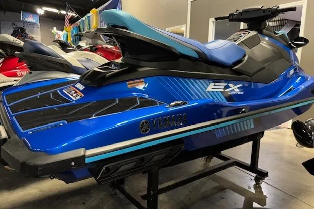 Slide: The Image of 2023 Yamaha WaveRunner EX Limited in blue, displayed indoors on a stand. - 18