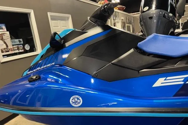 Slide: The Image of 2023 Yamaha WaveRunner EX Limited in showroom, featuring sleek blue design and ergonomic seating. - 7