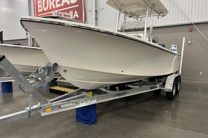 The Image of 2026 Maycraft 238CC boat on trailer in showroom, priced at $59,995. - 0