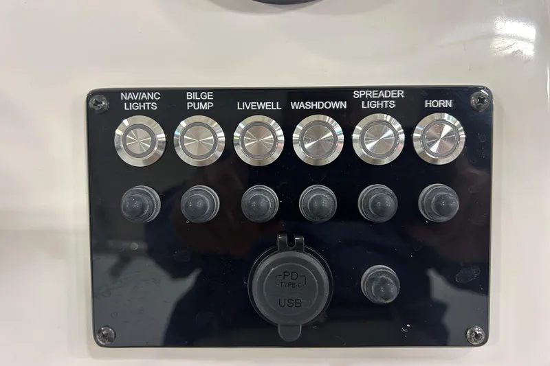 Slide: The Image of Control panel of 2026 Maycraft 238CC boat with labeled switches and USB port. - 11