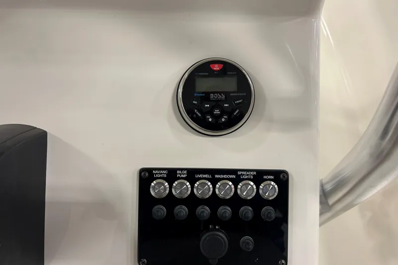 Slide: The Image of Control panel of 2026 Maycraft 238CC boat with audio system and switches. - 12