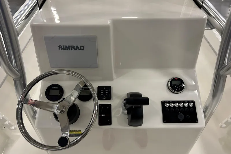 Slide: The Image of 2026 Maycraft 238CC boat console with Simrad display and steering wheel. - 13
