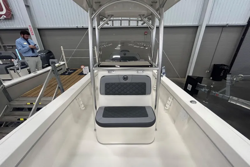 Slide: The Image of 2026 Maycraft 238CC boat interior with seating and console, displayed indoors. - 16